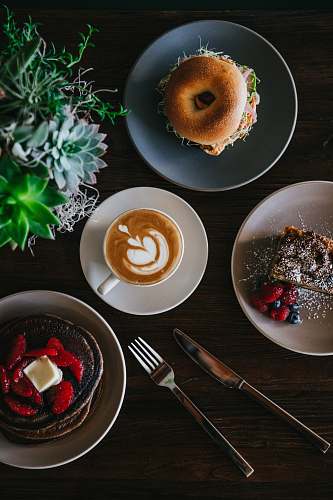 fruit coffee with latte art surrounded with sweets plant