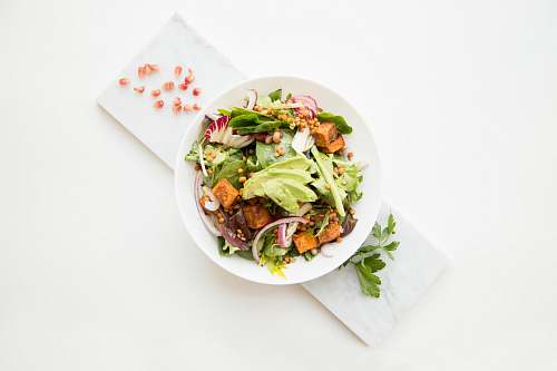 plant cooked food with sliced vegetables in white bowl dish