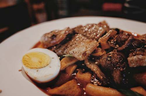 egg cooked food with white ceramic plate seasoning