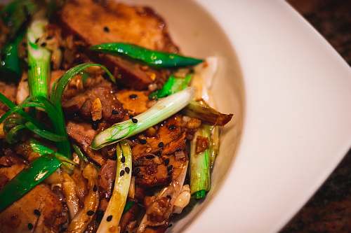 meal cooked meat with spring onions dish