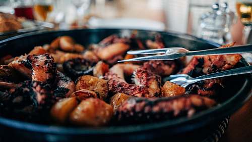 bbq cooked octopus in black bowl octopus