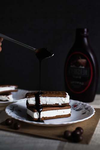 dessert cookies with cream and chocolate sauce on top of plate chocolate