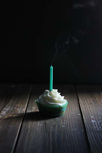 creme cupcake with candle on top dessert