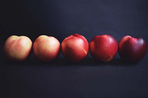 fruit five apples on black surface peach