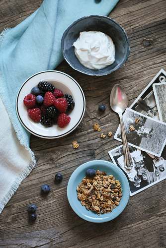 breakfast flat lay photograph of raspberries and whip cream bowl