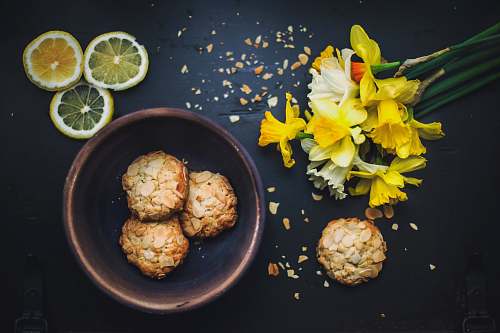 flower flat lay photography of cookies on bowl daffodil