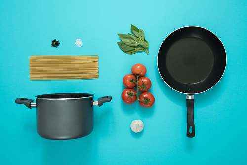 tomato flat lay photography of frying pan beside tomatoes on blue surface flora