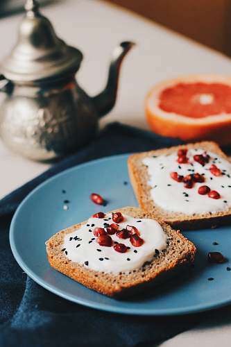 meal flatlay photography of spreaded bread beside teapot breakfast