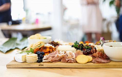 meal food and pastries on wooden chopping board dish
