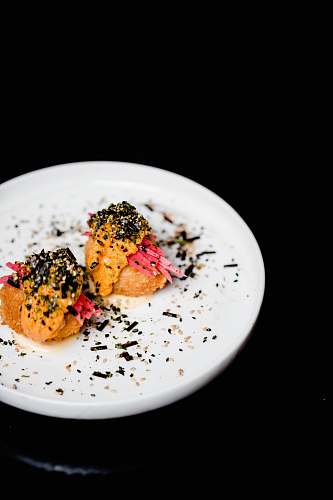 seasoning food on round white ceramic plate sesame