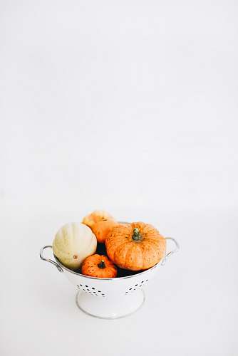 vegetable four round orange squashes on colander fall