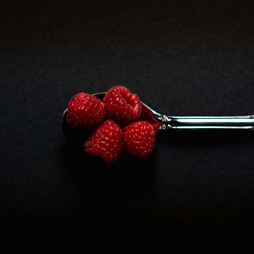 plant four Strawberry fruits on stainless steel spoon fruit