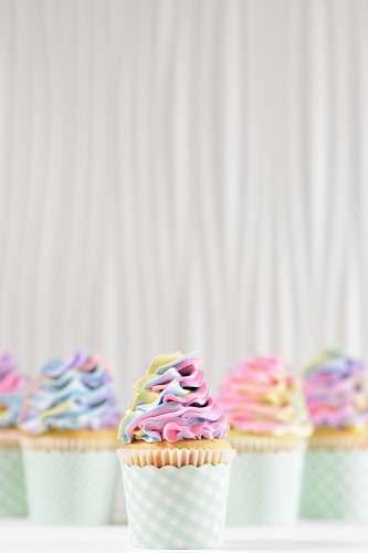 cream frosting on two cupcakes dessert