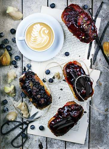 coffee fruit cakes, cappuccino and blueberries on gray wooden panel breakfast