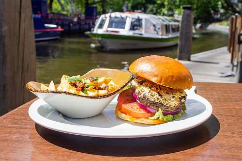 burger hamburger and salad on white tray boat