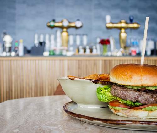 burger hamburger beside round white bowl bread