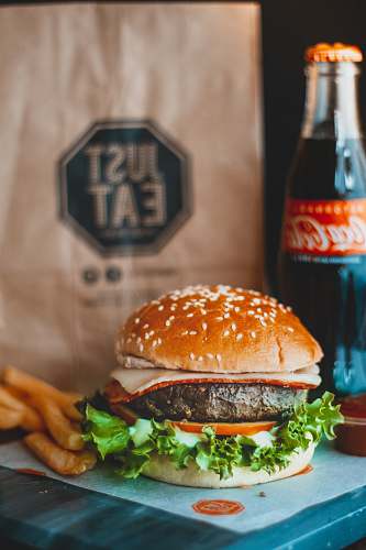 burger hamburger sandwich beside Coca-Cola bottle beverage