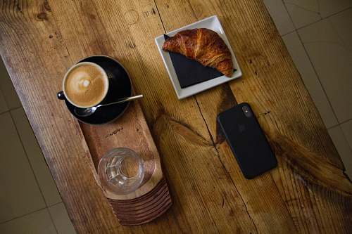 bread iPhone X on table croissant