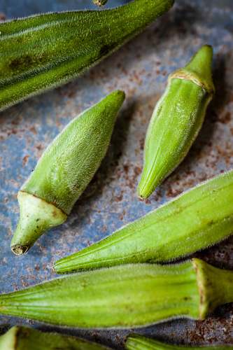 plant ladies fingers on blue and brown surface produce