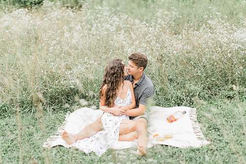 meal man and woman sitting on picnic mat vacation