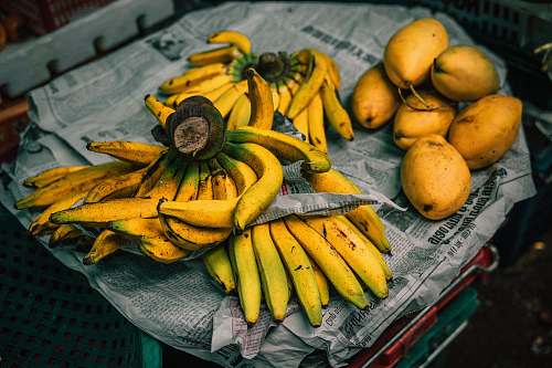 fruit mangoes and bananas on newspaper banana