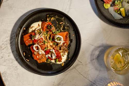 dish meat with red bell pepper and nuts on plate meal