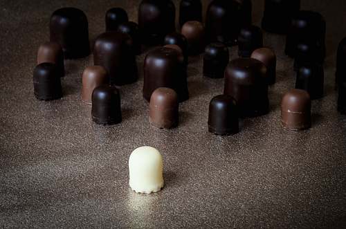 confectionery milk chocolate in front of scattered chocolates sweets