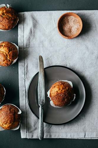 bread muffin on plate beside knife bun