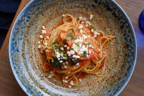 pasta noodles in brown and blue ceramic bowl spaghetti