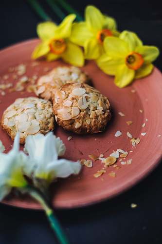 jar oatmeal cookies and daffodil flowers on plate flora