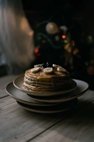 bread pancake on white ceramic saucer on table pancake