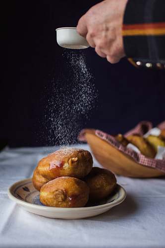 bread pastry sprinkled with sugar person