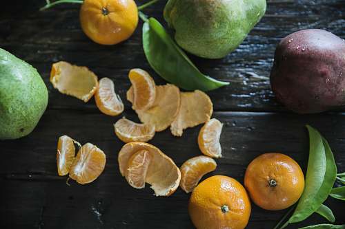 fruit peeled oranges on table surround with other fruits citrus fruit