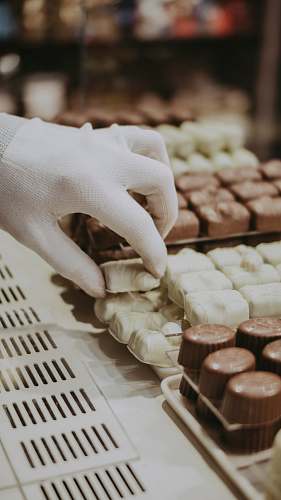 sweets person getting a milk chocolate truffle confectionery