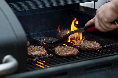 bbq person grilling hamburger patties people