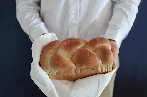bread person holding baked bread bun
