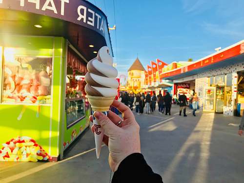 creme person holding ice cream dessert