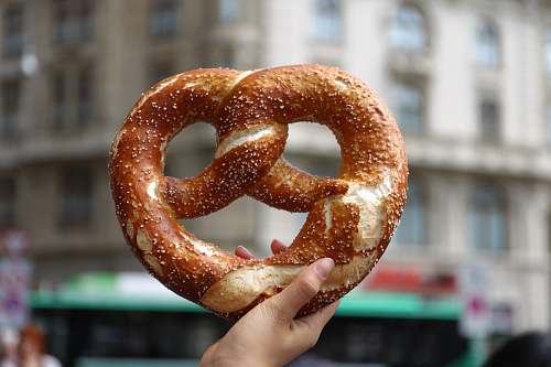 bread person holding pretzel pretzel