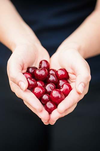 heart person holding red cherries person