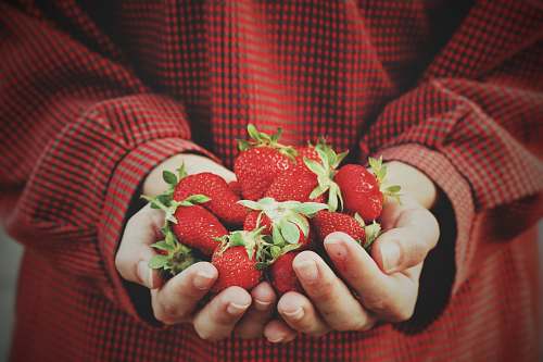 fruit person holding strawberries strawberry