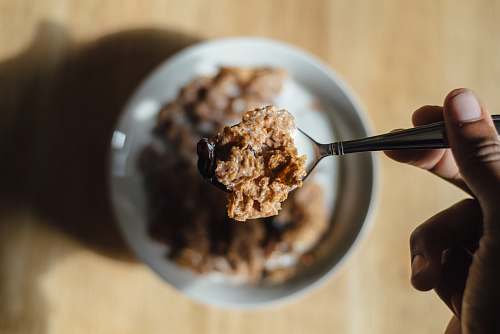 cereal person holding teaspon with cereal breakfast