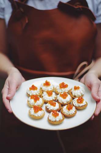 meal person holding tray of pastries person