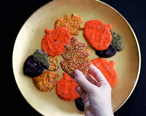 confectionery person picking Christmas tree themed cookie sweets