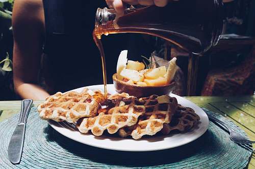 waffle person poring syrup on waffles human