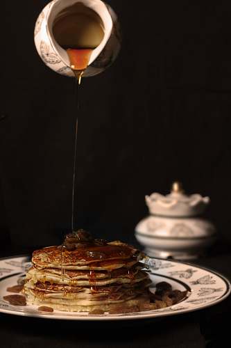 bread person pouring honey on pancakes pancake