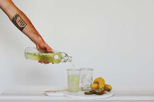 drink person pouring juice on glasses on table glass