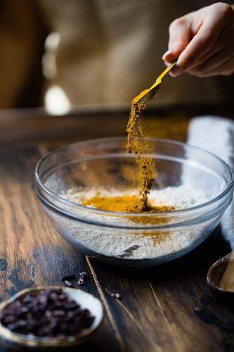 cooking person pouring seasonings on clear glass bowl springfield