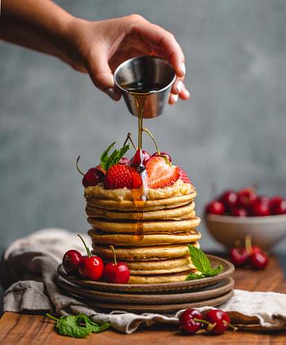 bread person pouring syrup on pancake pancake