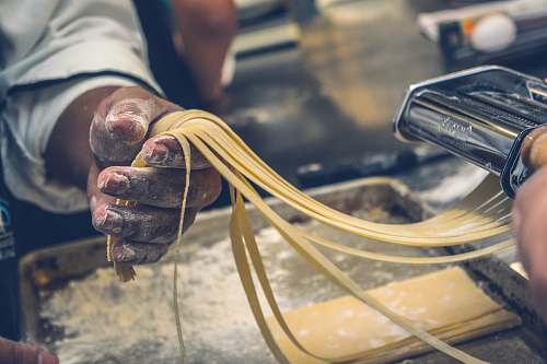 italian person sheeting dough cooking