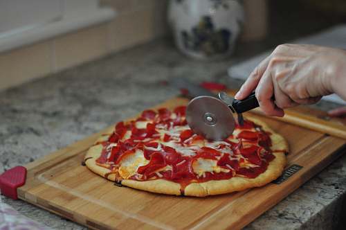 pizza person slicing pizza human